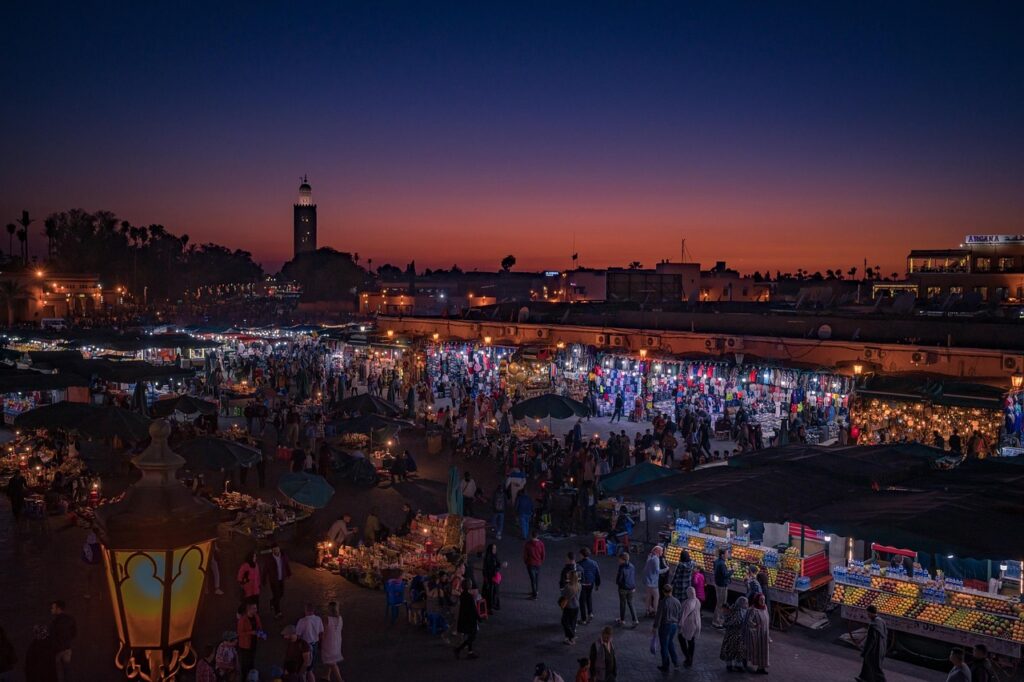 The Soul of Morocco Night view of a bustling Moroccan night market in Marrakech with glowing lights and historic architecture