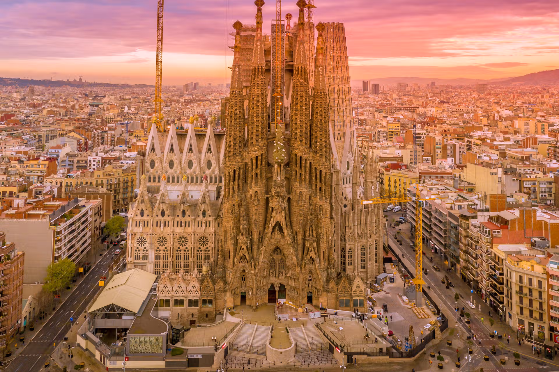 Booking Park Güell + Sagrada Familia Together? Read This First Aerial view of the Sagrada Familia's towers rising over Barcelona at golden hour