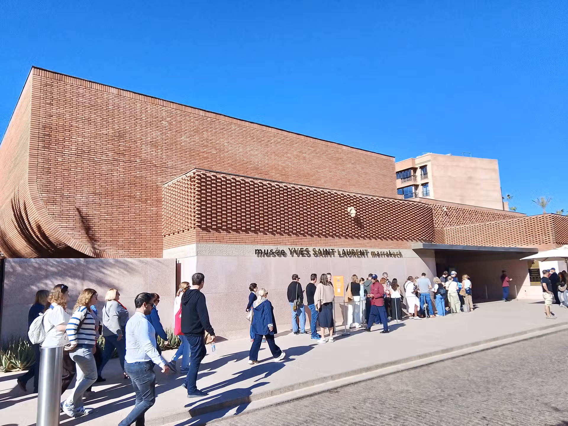 Tourists queuing outside Musée Yves Saint Laurent Marrakech entrance
