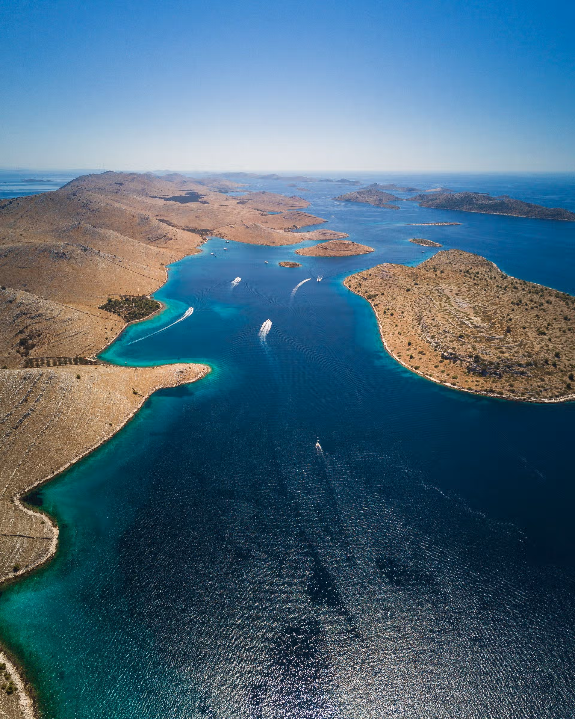 Booking a Kornati Day Trip? Read the Reviews First Aerial view of speedboats crossing the turquoise channel between the limestone islands of Kornati National Park, Croatia