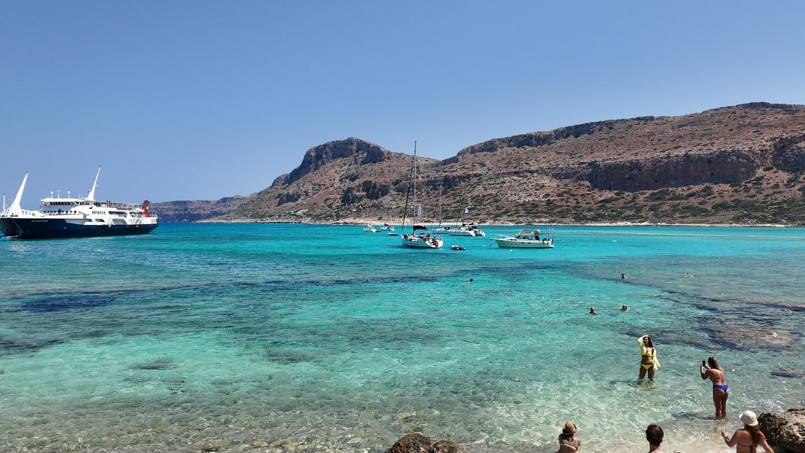 Aerial view of Balos Lagoon's turquoise water and pink-tinged sand on Crete's northwest coast